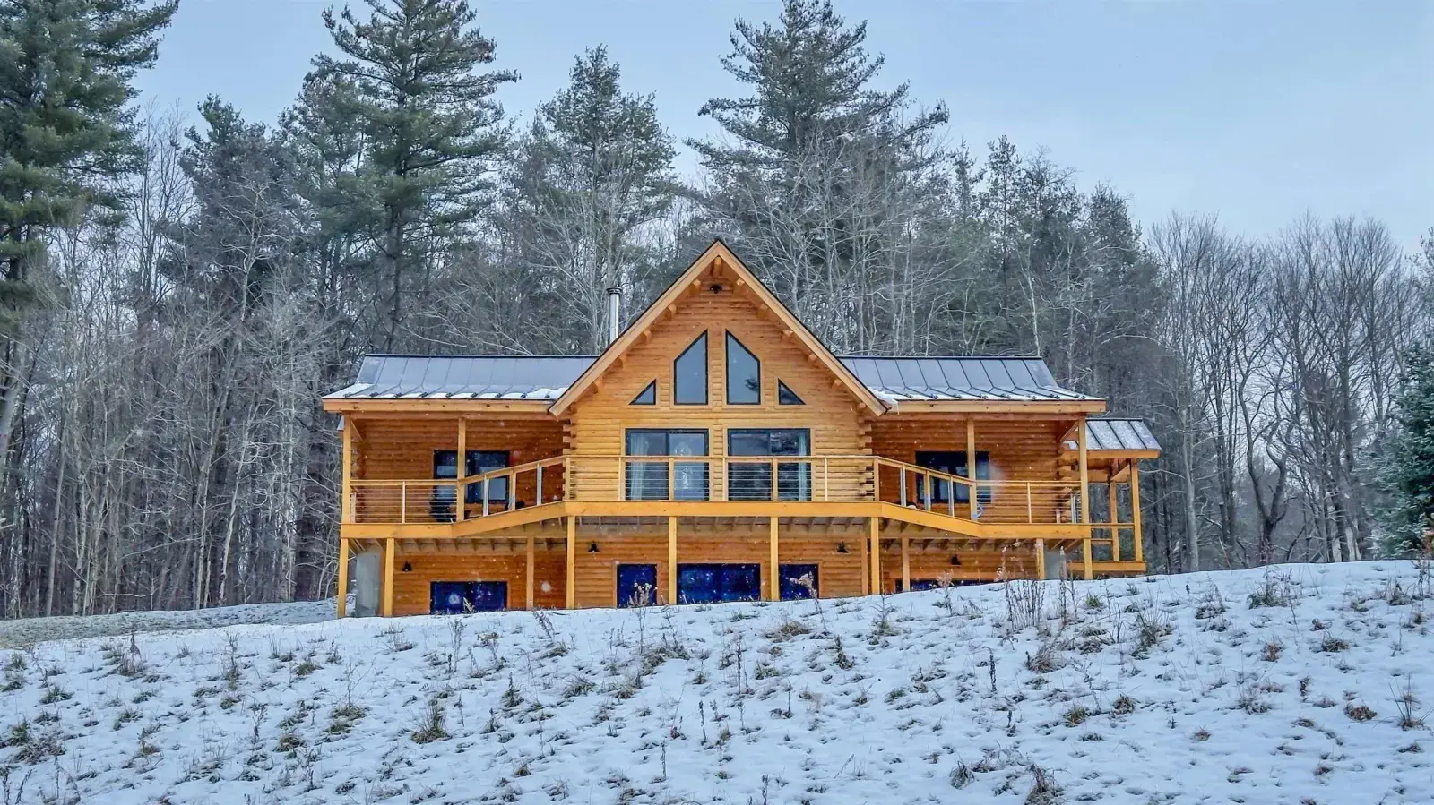Cedar log home with a covered porch from the Moosehead photo gallery
